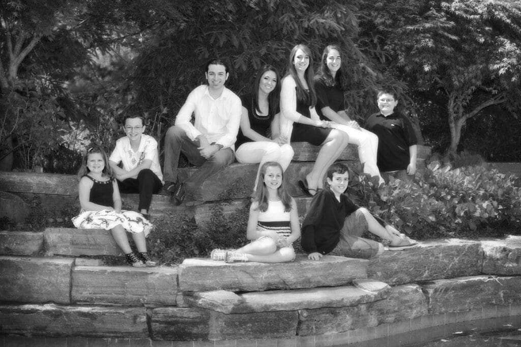 A group of people sitting on top of rocks.