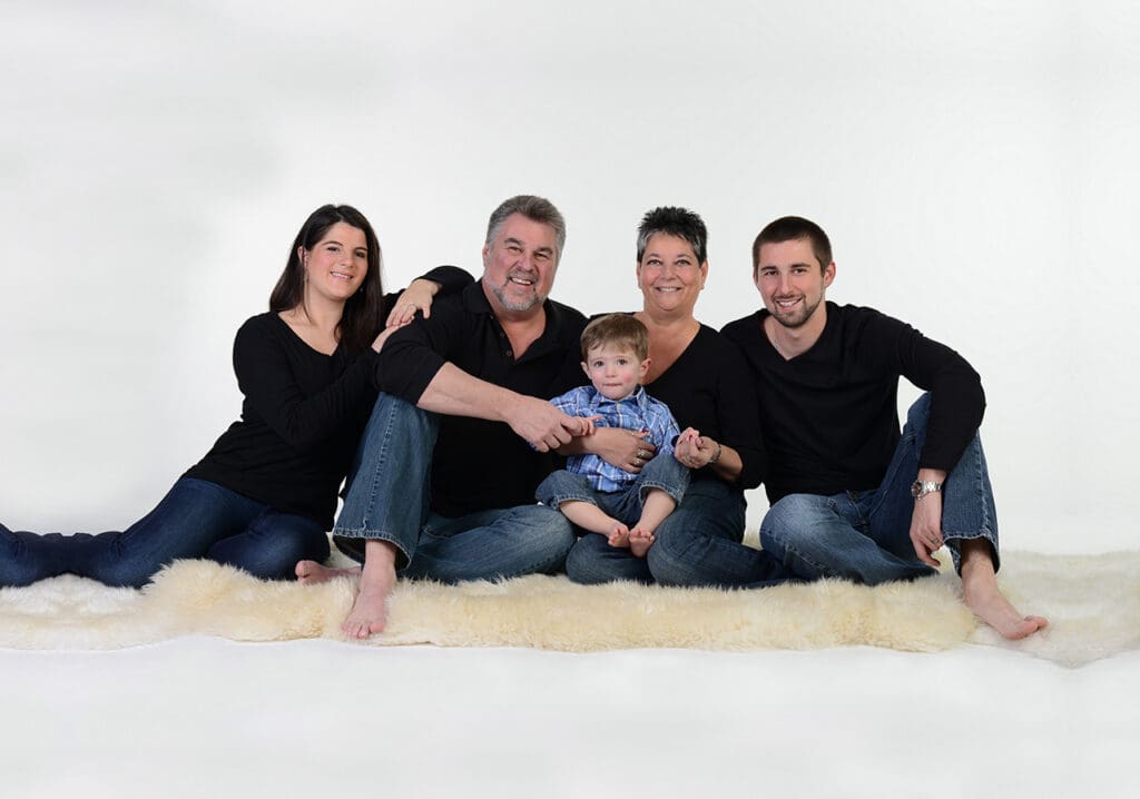 A family posing for a picture in front of the camera.