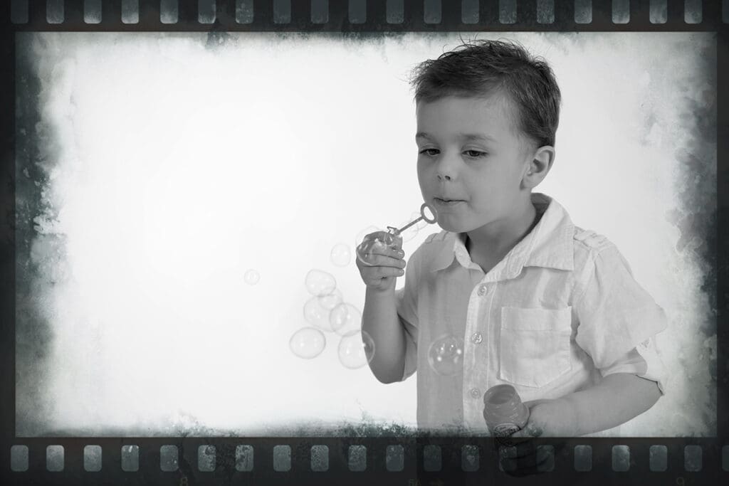 A young boy brushing his teeth with an electric toothbrush.