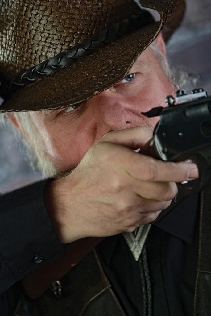 A man in a hat is holding a camera