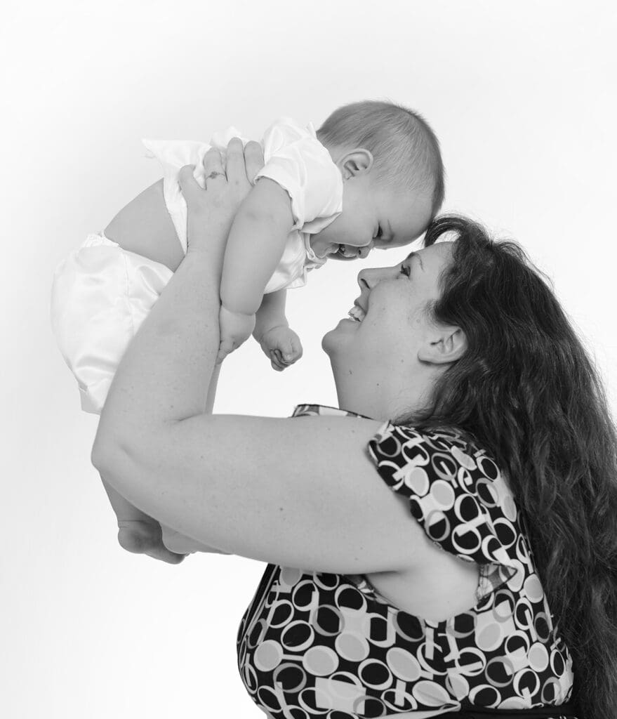 A woman holding a baby in her arms.