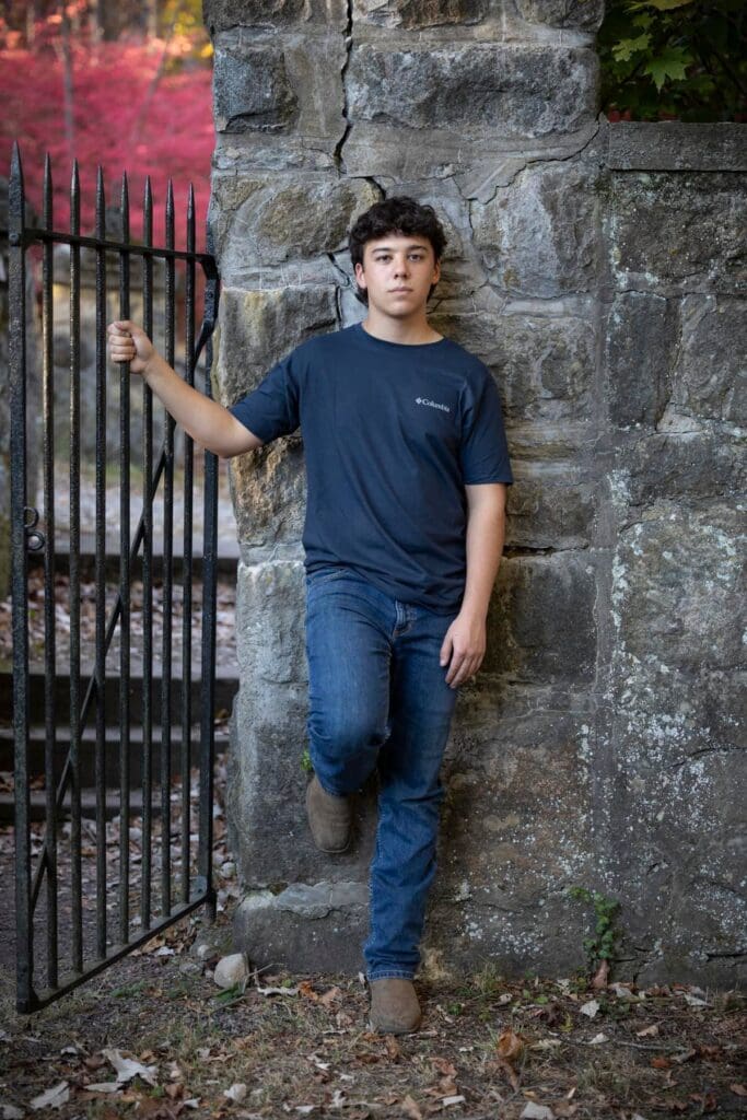 A man leaning against the wall of an old building.